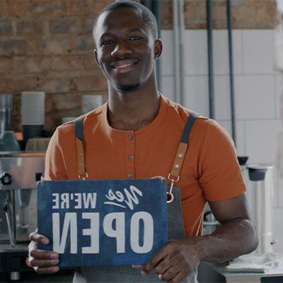 man holding open sign